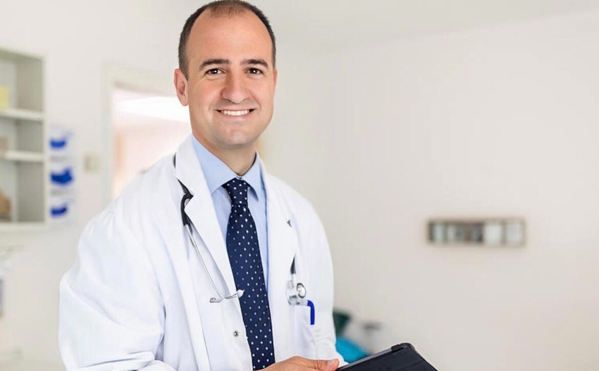 A smiling male doctor in a white coat and striped tie, holding a clipboard, standing in a bright hospital room, preparing for the MCCQE Part 1 and ready to deep dive into the best MCCQE1 Qbank.