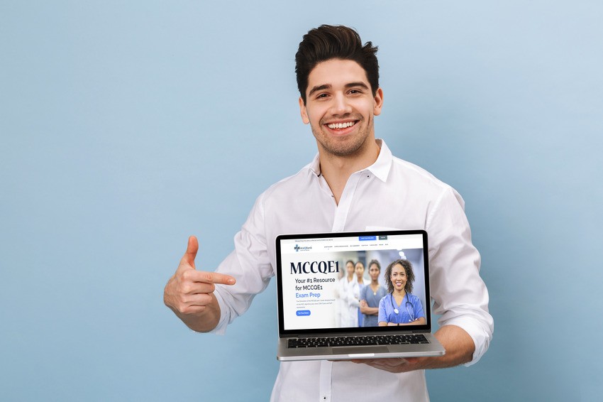 A man in a white shirt is smiling and pointing to a laptop displaying the MCCQE1 website for exam preparation, highlighting the benefits of using the Ace QBank online question bank for acing the MCCQE Part I.