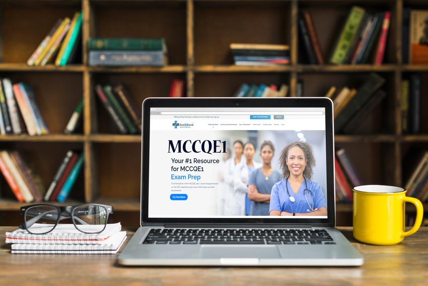 Open laptop on a desk with an MCCQE1 exam preparation website displayed on the screen. Bookshelves are in the background. The desk also has a coffee mug, glasses, and notebooks from Ace QBank.