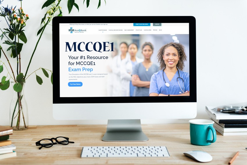 A computer screen displays the "MCCQE1 exam preparation" website, featuring an image of smiling medical professionals. A desk with a plant, books, and a green mug is visible in the foreground, making it clear that this setup is designed to be your shortcut to acing the MCCQE1.