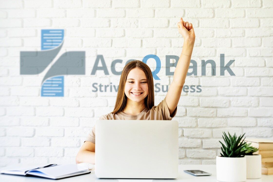 A woman sitting. Behind her is a white wall featuring the "Ace Bank" logo and the tagline "Striving for Success." The desk is adorned with a plant and MCCQE1 exam prep books.