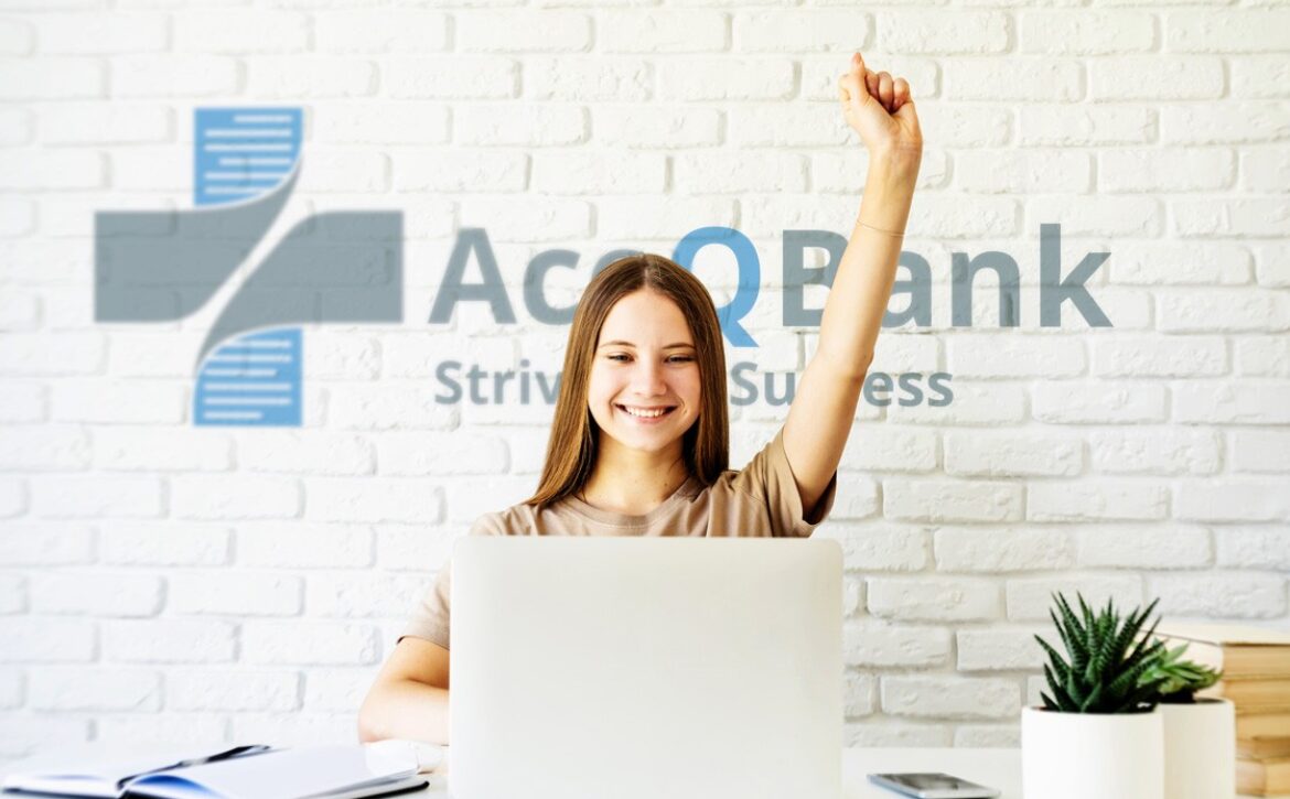 A woman sitting. Behind her is a white wall featuring the "Ace Bank" logo and the tagline "Striving for Success." The desk is adorned with a plant and MCCQE1 exam prep books.