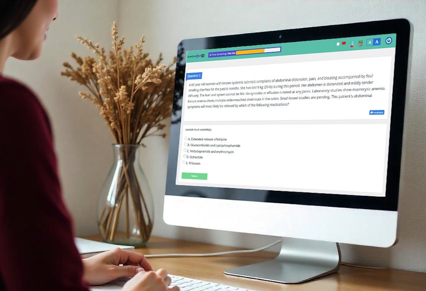 A person is using a desktop computer to ace their online quiz, utilizing the extensive Ace QBank. On the left side of the desk, a vase with dried flowers adds a touch of nature to the focused study space.