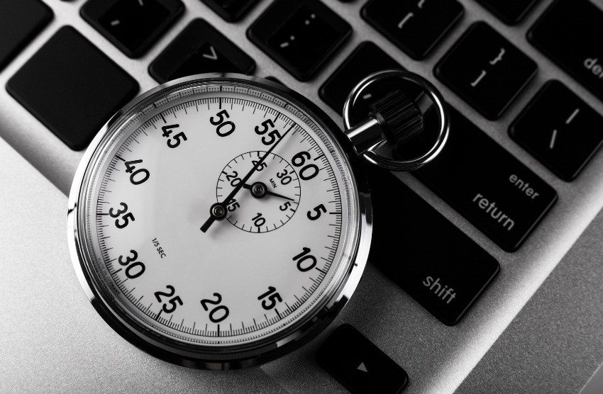 A stopwatch rests on a laptop keyboard, displaying 60 minutes and 30 seconds as you answer questions in Ace QBank, the best Canadian question bank for MCCQE1.